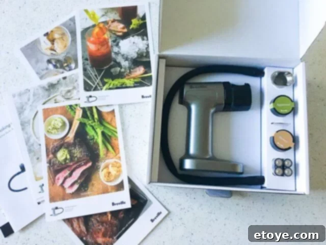 Delicious Smoked Olives Using a Smoking Gun 6 The Polyscience Smoking Gun laid out with its accessories, including wood chip samples, batteries, and mesh screens.