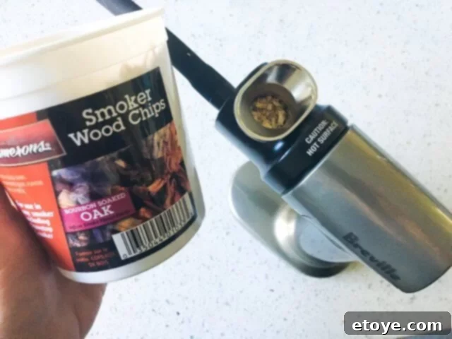 Delicious Smoked Olives Using a Smoking Gun 7 A small pinch of wood chips being carefully placed into the chamber of the Smoking Gun.