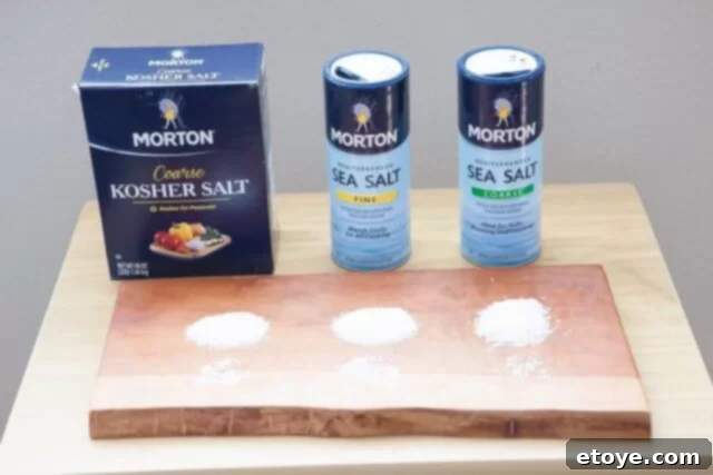 Three different types of Morton salt containers: Kosher, Fine Sea, and Coarse Sea Salt, neatly arranged