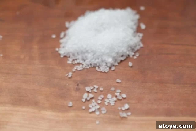 A close-up of Morton Coarse Sea Salt crystals, showing their large, chunky, and distinctive size