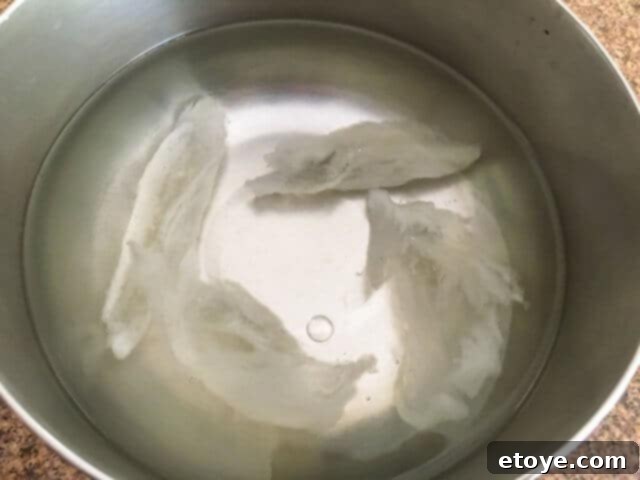 Exquisite Chinese Bird's Nest Soup 6 Soaked bird's nest in a pot, ready for the next stage of preparation.