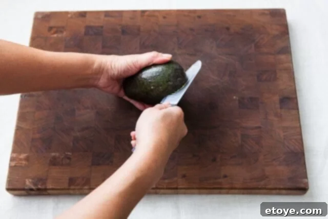 Grapefruit, Avocado and Baby Arugula Salad 13 Cutting avocado again to create four segments