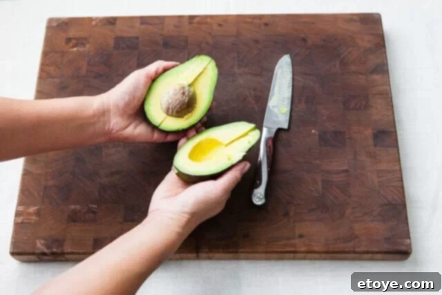 Grapefruit, Avocado and Baby Arugula Salad 14 Twisting avocado halves to separate
