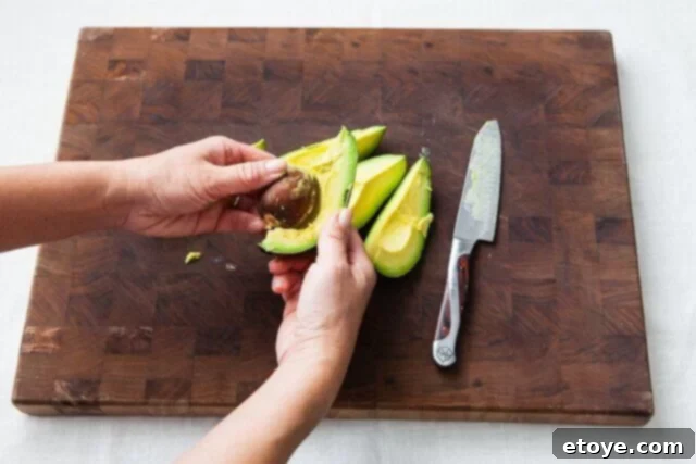 Grapefruit, Avocado and Baby Arugula Salad 18 Removing pit from smaller avocado segment