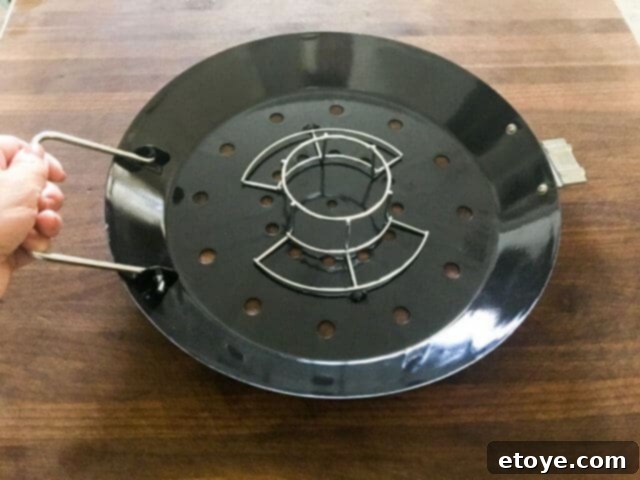 STOK Gridiron Grill with chicken roaster insert, surrounded by carrots and potatoes