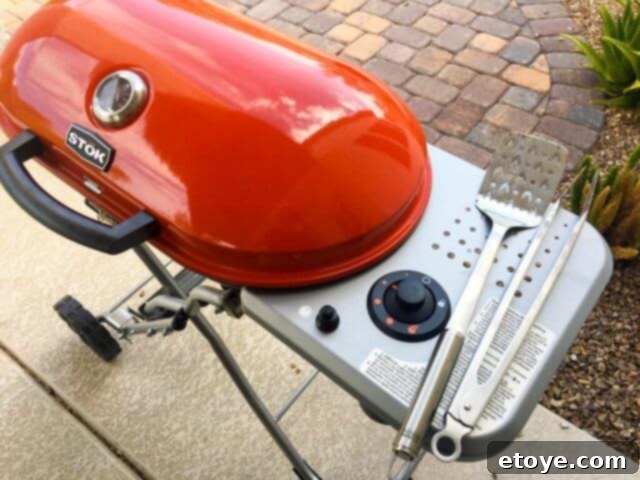 Another perspective of the STOK Gridiron Grill's integrated side table providing extra workspace