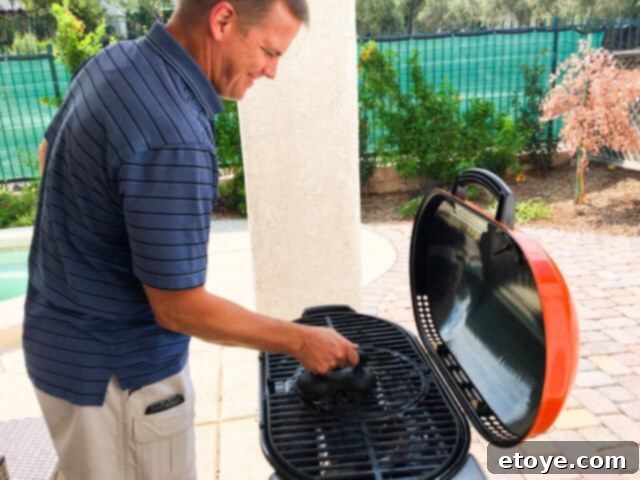 Lifting the STOK Gridiron Grill's cast iron grates for deeper cleaning of the interior