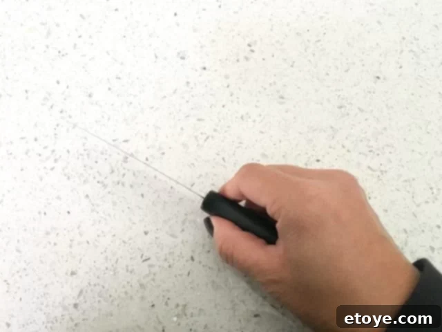 A top-down view of a Kuhn Rikon Colori Titanium knife, emphasizing its slender profile.