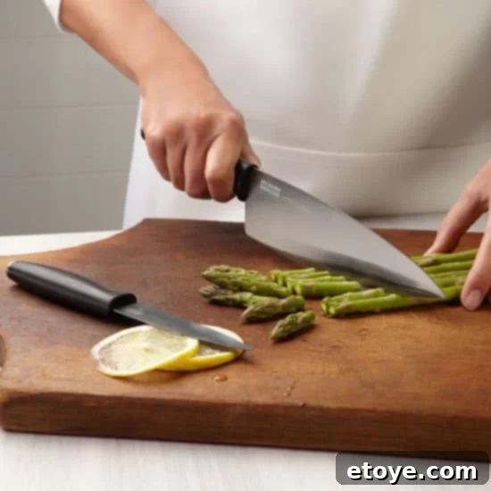 An array of Kuhn Rikon Colori Titanium knives, featuring various sizes and their distinct gray and black handles.