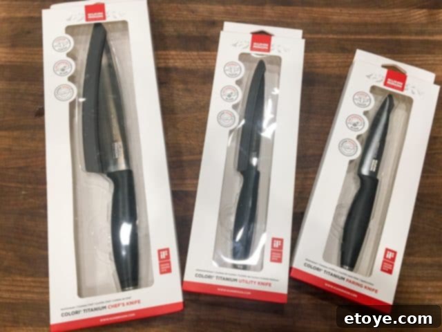 Close-up of the handles and blades of two Kuhn Rikon Colori Titanium knives, highlighting their clean finish.