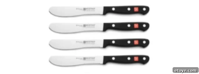 Four Wusthof Gourmet Burger Knives neatly arranged.