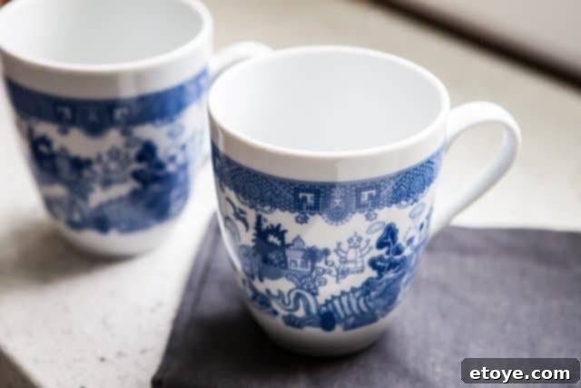 Another perspective of Calamityware mugs, highlighting detailed whimsical illustrations and artistic quality