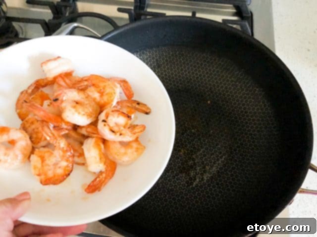 Shrimp Teriyaki Recipe stir fry shrimp Shrimp Teriyaki Recipe removing half-cooked shrimp from the wok