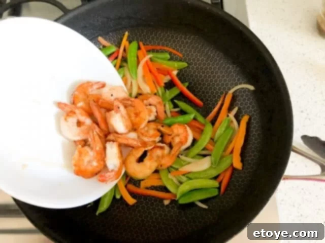 Shrimp Teriyaki Recipe stir fry vegetables Shrimp Teriyaki Recipe adding half-cooked shrimp back to the vegetables