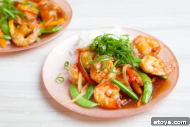 Shrimp Teriyaki Recipe Shrimp Teriyaki Recipe served in a bowl with chopsticks, garnished with green onions