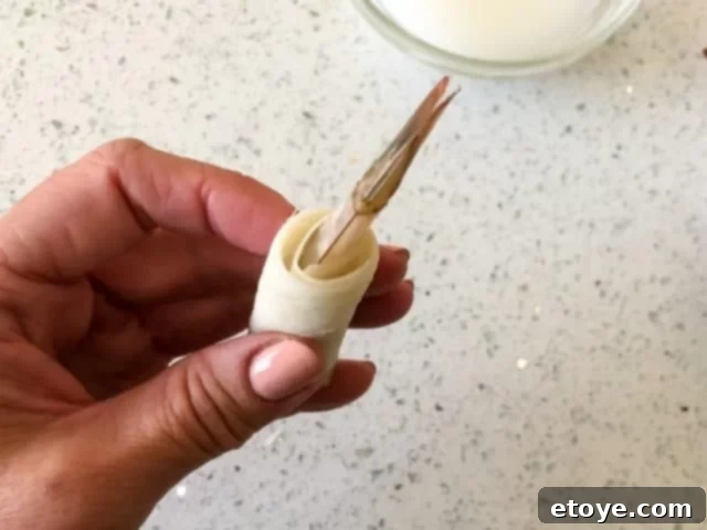 hand holding shrimp in wrapper