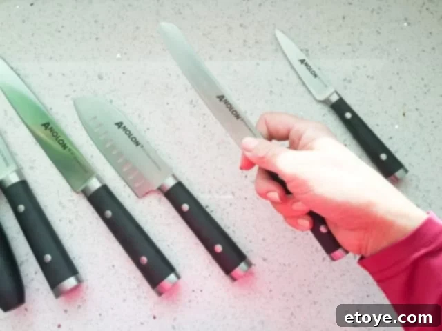 Anolon 17-Piece Japanese Knife Set Review Plus a Chance to Win 4 Anolon 17-Piece Japanese Serrated Utility Knife slicing tomatoes