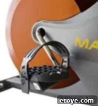 Detailed view of the counterbalanced pedals with adjustable foot straps