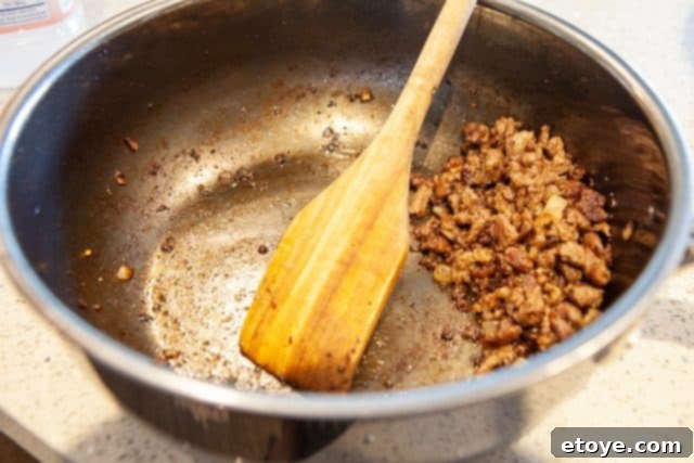 Hestan Nanobond Essential Pan Review & Giveaway 6 Metal spatula smoothly interacting with food in the Hestan Nanobond Essential Pan, highlighting scratch resistance