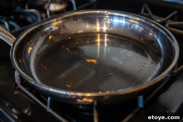 Hestan Nanobond Essential Pan Review & Giveaway 8 Melted cheese effortlessly peeling off the Hestan Nanobond Frying Pan, demonstrating superior food release