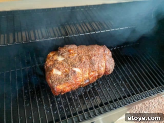 Checking pork butt during smoking
