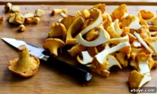 chanterelle-bacon-blue-cheese-plum-salad-28 Close-up of trimmed and prepared chanterelle mushrooms on a cutting board