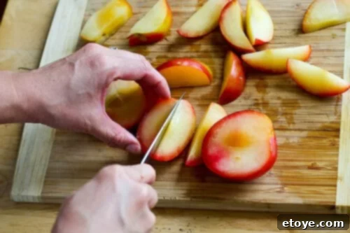 chanterelle-bacon-blue-cheese-plum-salad-44 Plum sections being cut into wedges on a cutting board