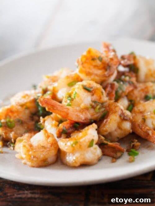 Asian Shrimp Delights 3 Shrimp stir-fry on a white plate with vegetables and sauce