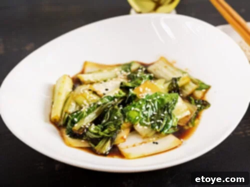 3-Minute Microwave Bok Choy 2 Cooked bok choy in sauce, garnished with sesame seeds