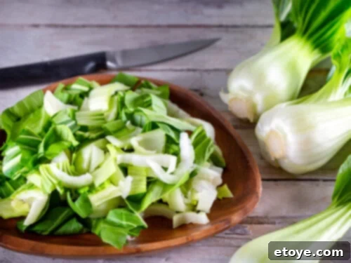 3-Minute Microwave Bok Choy 3 Chopped baby bok choy in a wooden bowl, ready for cooking