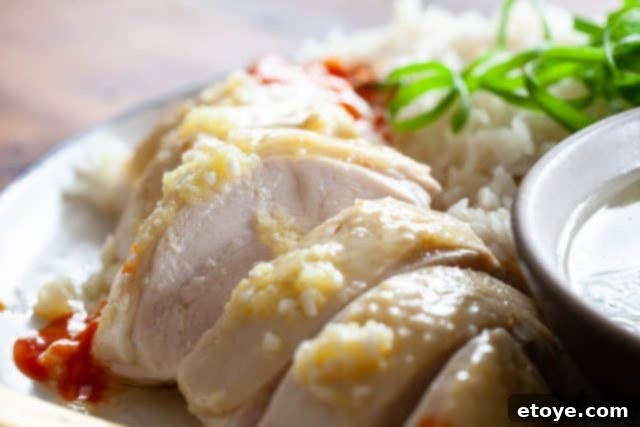 Homemade Hainanese Chicken Rice Perfection 2 Authentic Hainanese Chicken Rice served with dipping sauces and cucumber