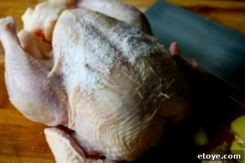 Hainanese Chicken Rice Recipe - Rub chicken with salt Rubbing chicken with kosher salt for exfoliation