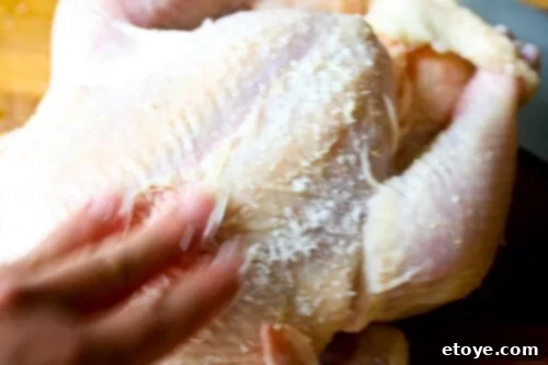 Hainanese Chicken Rice Recipe - Rub chicken with salt Thoroughly rubbing the chicken skin with salt