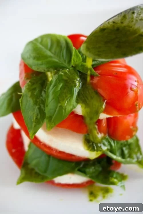 Basil Vinaigrette Drizzle Action Close-up of Basil Vinaigrette Drizzle on Caprese Salad