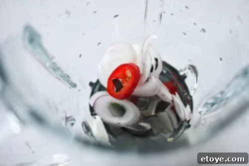 How to Make Basil Vinaigrette Step 1 Blending Basil Vinaigrette: Adding Basil Leaves, Salt, Vinegar, Water