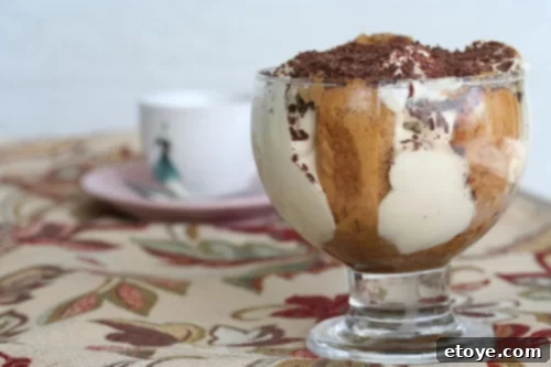 Decadent Tiramisu served in individual glasses, highlighting layers of creamy mascarpone and coffee-soaked ladyfingers, garnished with chocolate shavings.