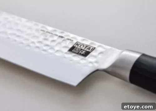 KOTAI Gyuto Knife with its sleek black Pakkawood handle and red detailing