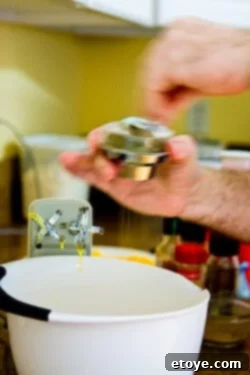 Pouring the egg mixture over cheese in a soufflé dish