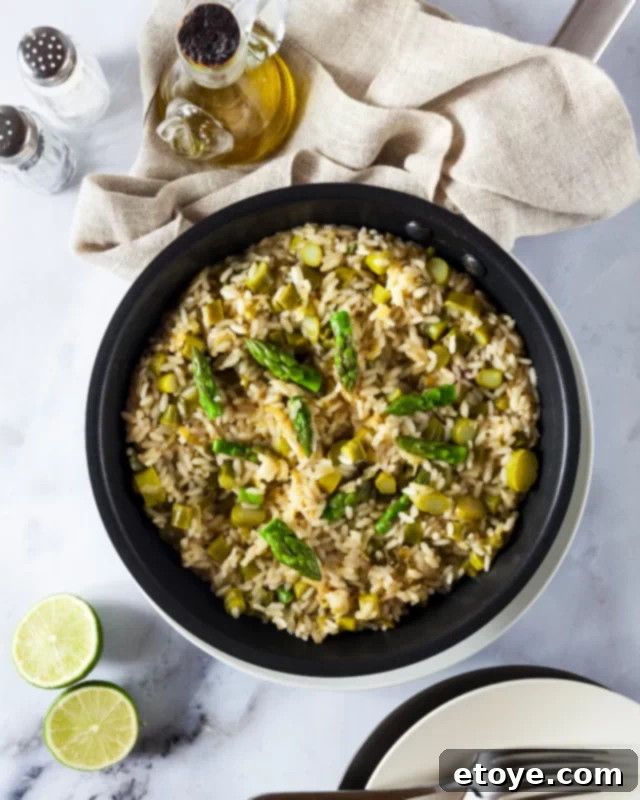 Close-up of asparagus with grated cheese and lemon zest on a serving plate