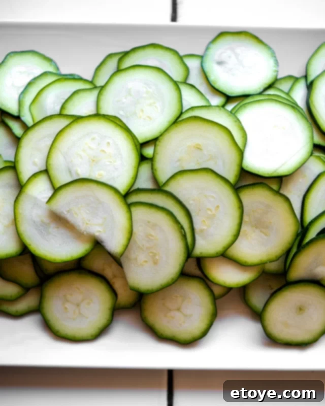 Close-up of freshly steamed zucchini coins in a bowl