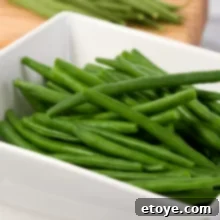 The Easiest Microwave Steamed Green Beans 6 steamed green beans in a bowl