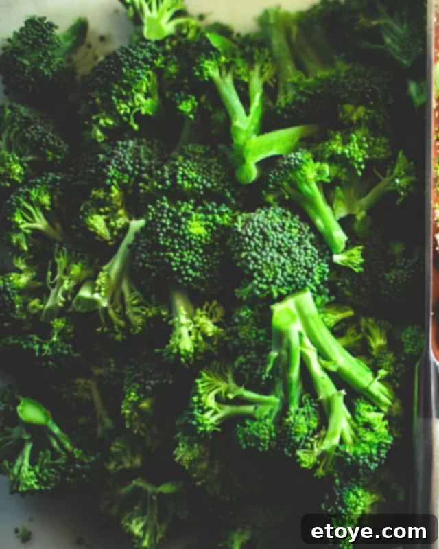 Easy Microwave Steamed Broccoli 2 Fresh broccoli florets in a microwave-safe bowl, ready for steaming.
