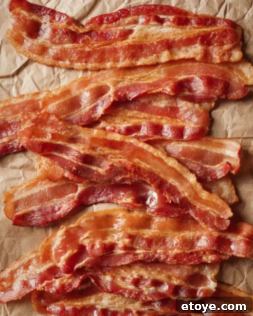 Perfect Microwave Bacon Every Time 2 Crispy bacon slices on a white plate