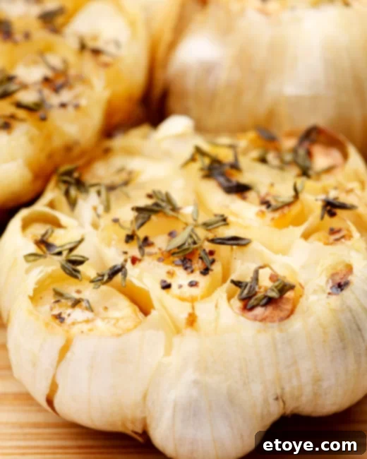 Quick Microwave Roasted Garlic 5 A close-up of golden, tender microwave roasted garlic cloves, extracted from the head and ready for use