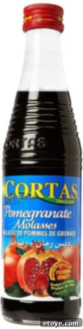 Bottle of authentic pomegranate molasses, a key ingredient for the sweet and tangy sauce.