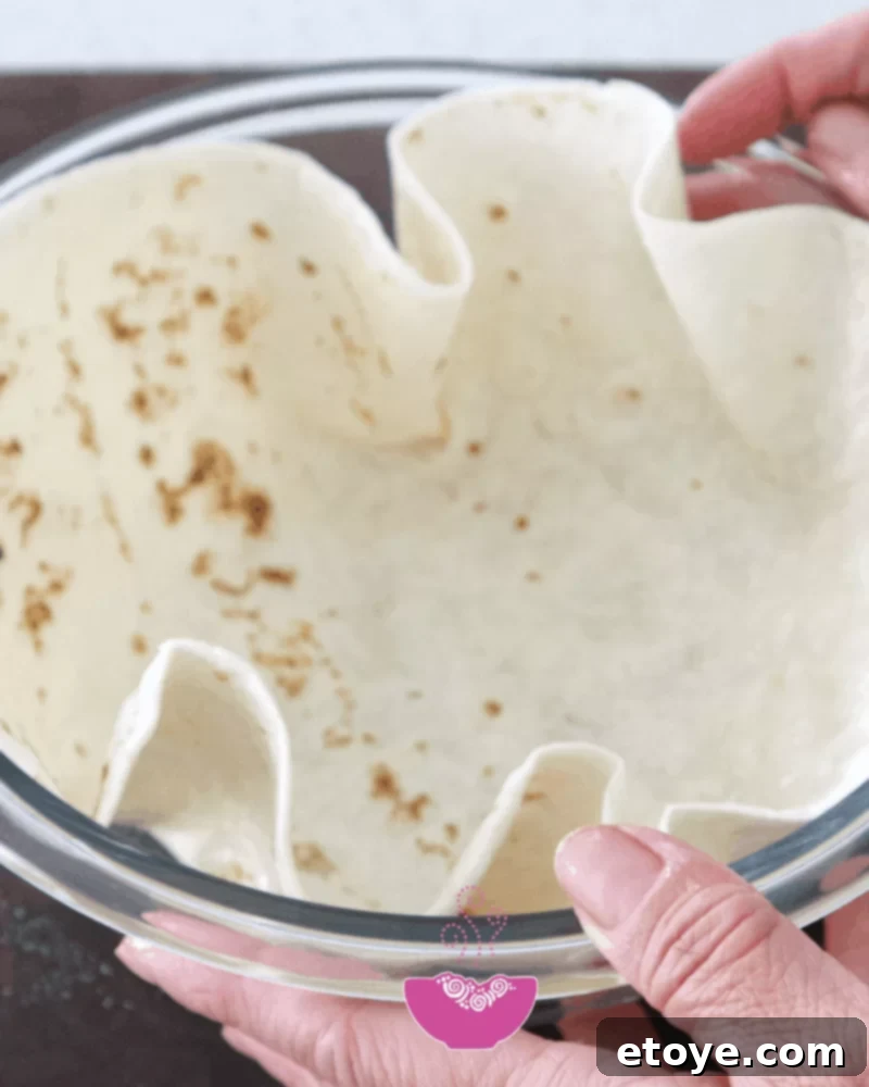 A beautifully golden-brown crispy tortilla bowl, ready to be filled with delicious ingredients.