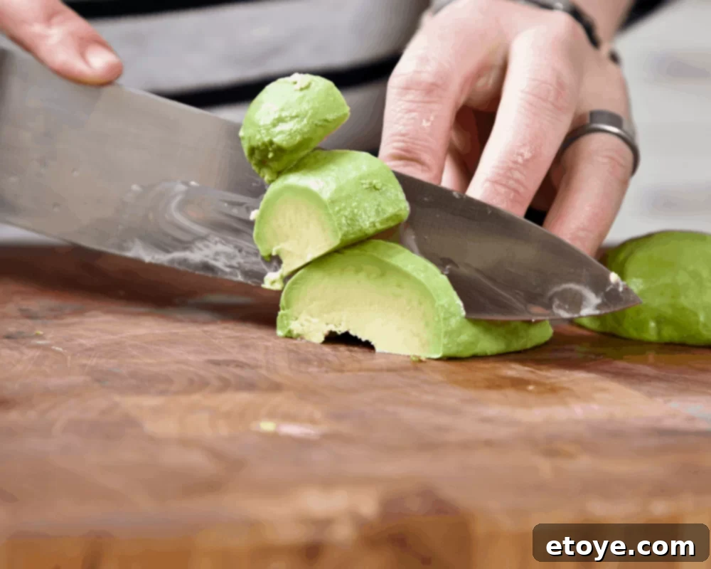 Avocado Slicing Made Simple 7 Avocado flesh being sliced on a cutting board