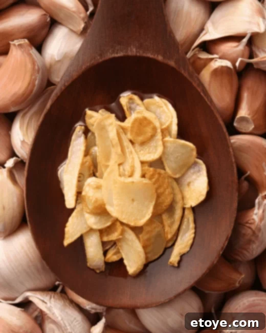 Golden Crispy Garlic 3 Fried garlic on a spoon, showing its golden texture