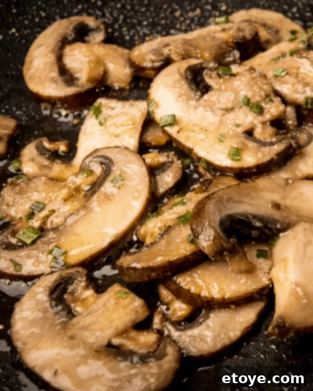 Close-up of perfectly sautéed mushrooms, golden and seasoned