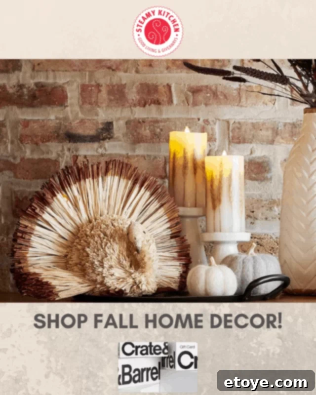 Win a Crate and Barrel 100 Gift Card 3 Cozy autumn living room with fall-themed decor from Crate and Barrel, including plush throw blankets, scented candles, and decorative pumpkins, creating a warm ambiance.